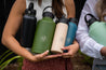 An assortment of Dawny reusable water bottles being held