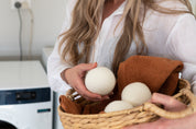 Laundry basket with three dryer balls on top