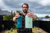 Man holding a 950ML and 1.9L reusable stainless steel water bottle