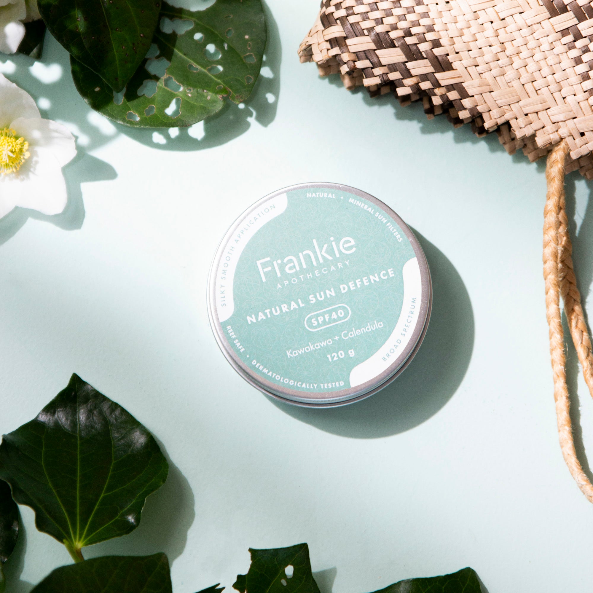 CaliWoods Sunscreen Natural Sunscreen SPF40 Non-toxic made in New Zealand NZ on blue background with Kawakawa and Calendula flower and flax Kite