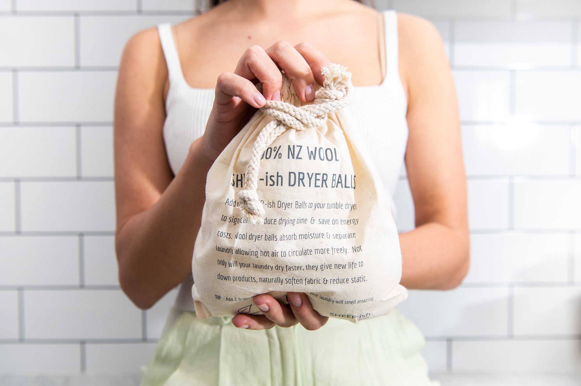Bag of CaliWoods Dryer Balls being held in two hands