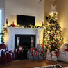 Christmas scene by the fireplace with reusable Gift Bags