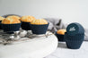 Plain muffins on a cooling rack in reusable silicone Muffin Cups