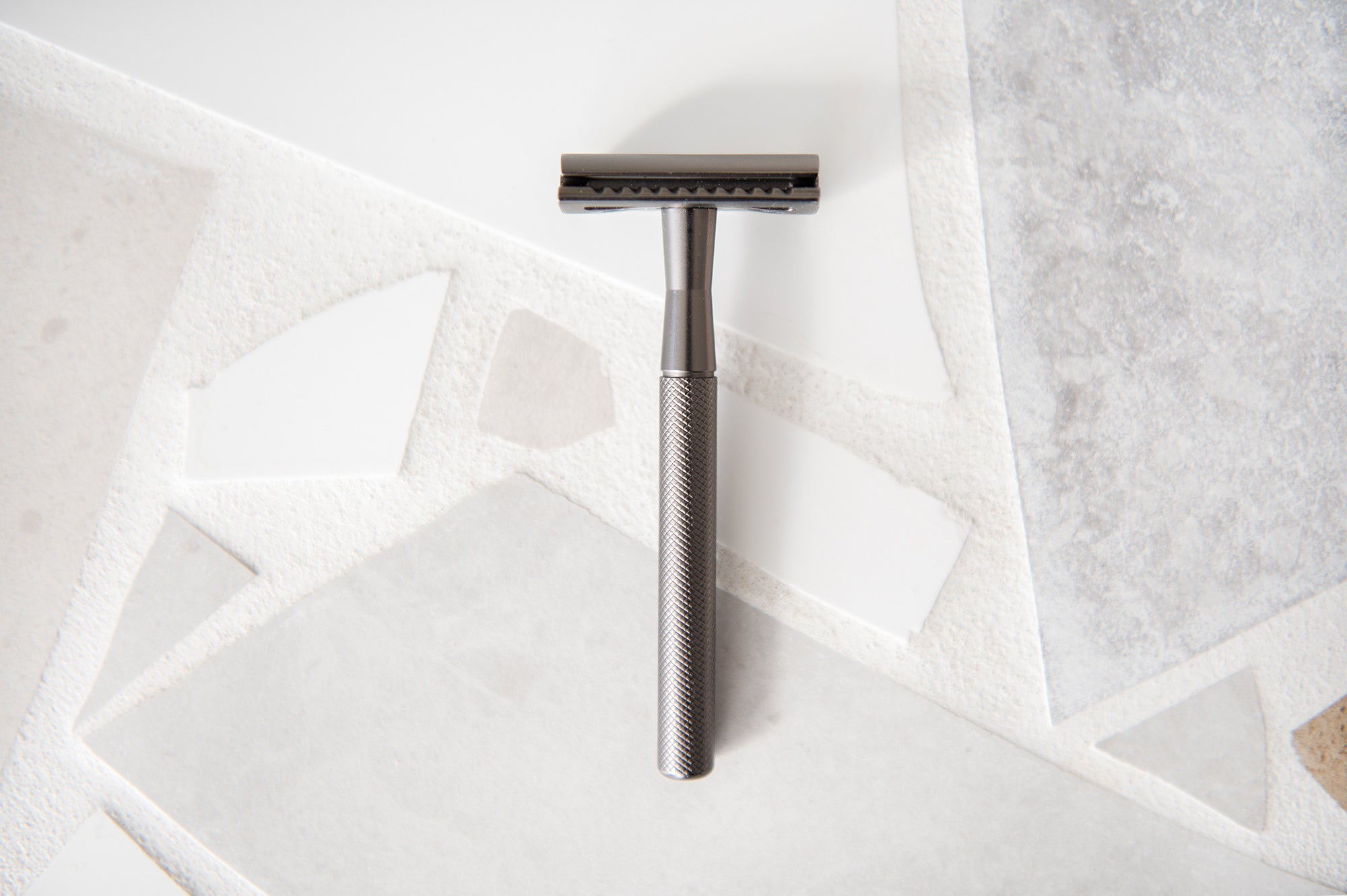 The Slate Safety Razor on a tiled bench