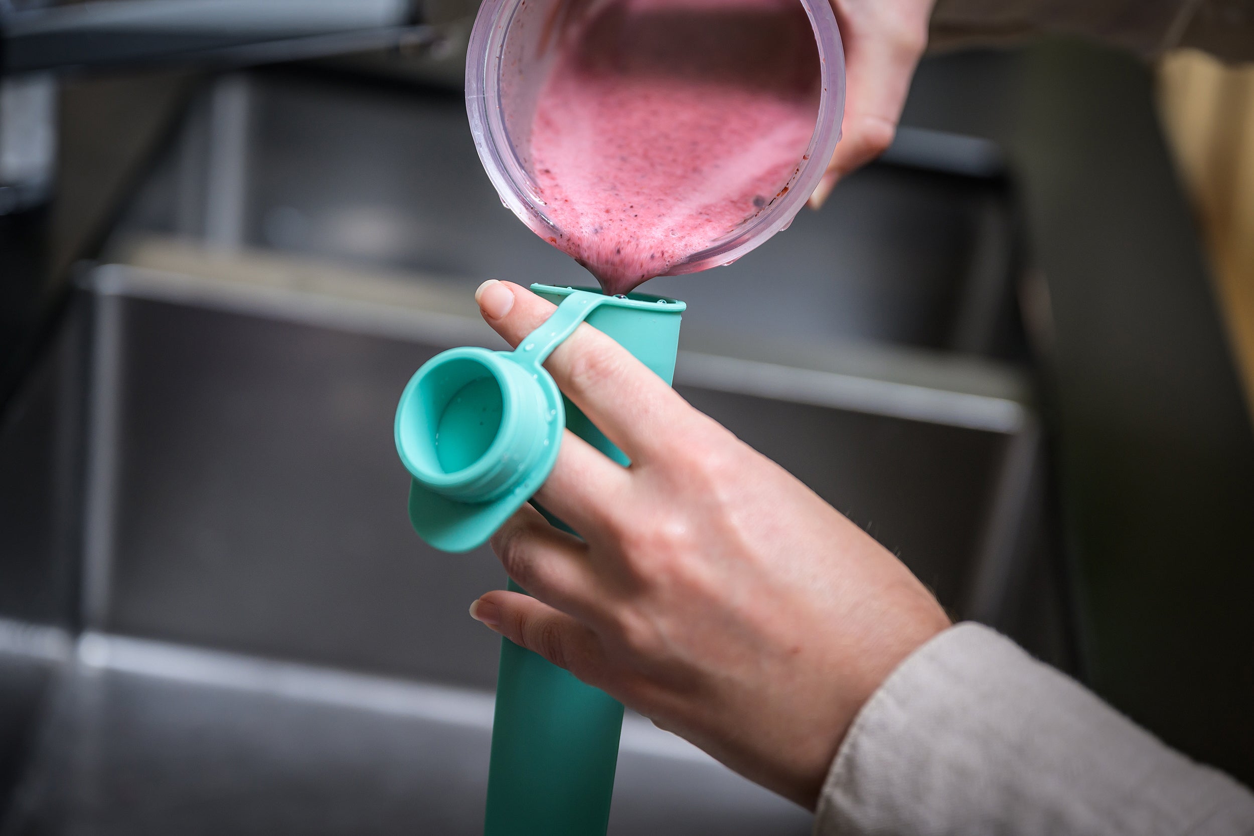 teal CaliWoods Ice Block Mould with berry ice block being poured in 