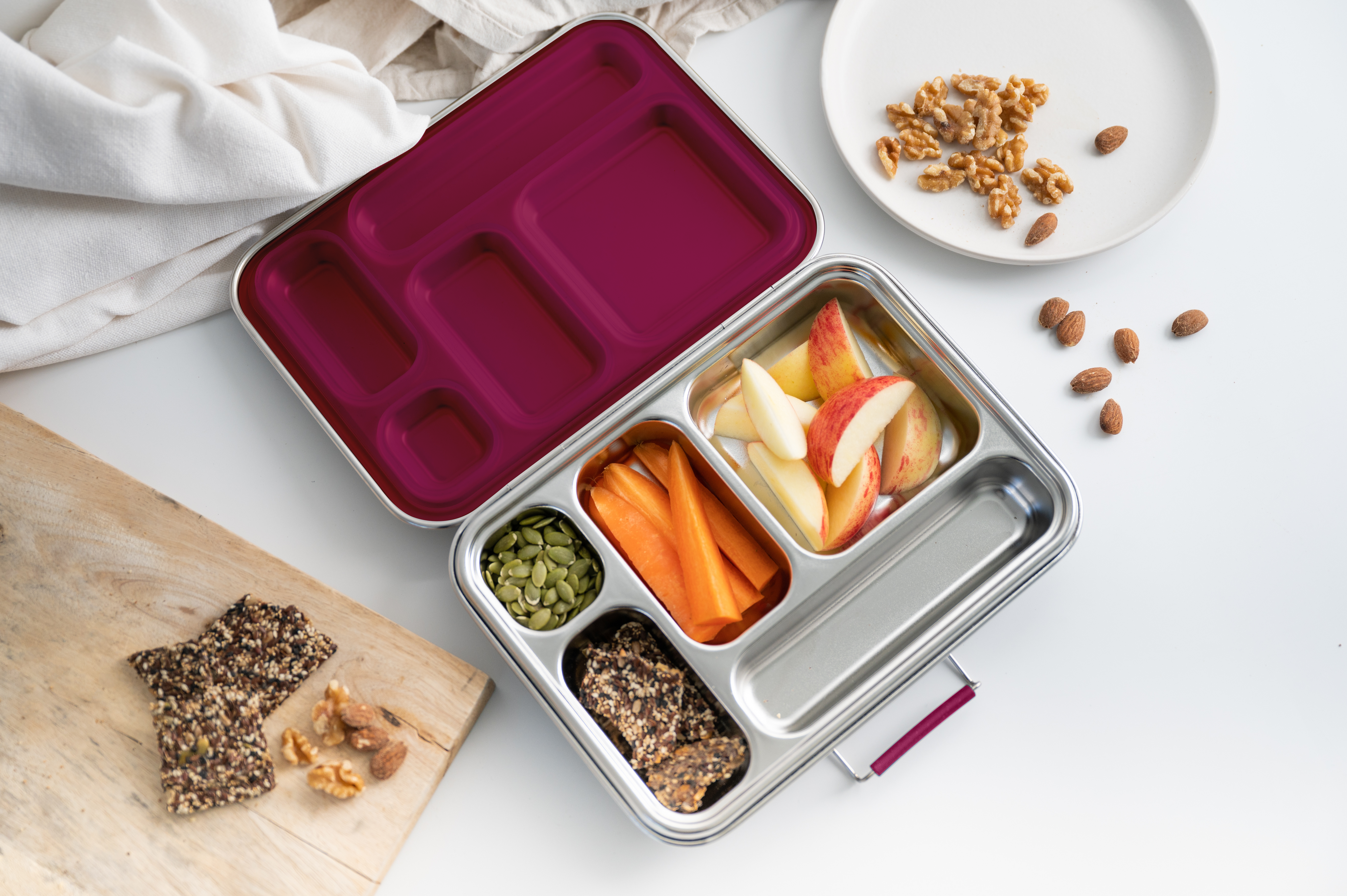 Stainless Steel Lunch Box Bento with carrots, apples, seeds and crackers