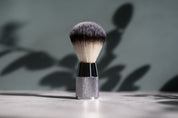 silver shaving brush on grey background