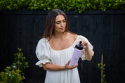 Woman holding 530ML reusable water bottle that fits in car holder