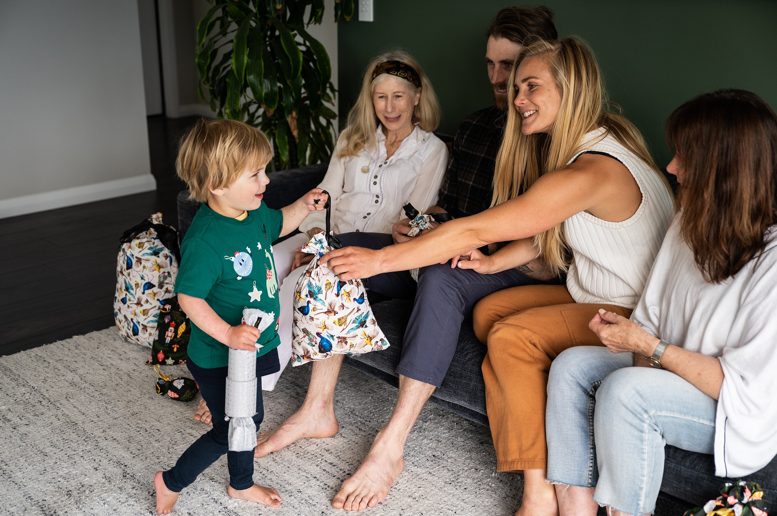 Mum giving a gift to her son in a eco fabric gift bag