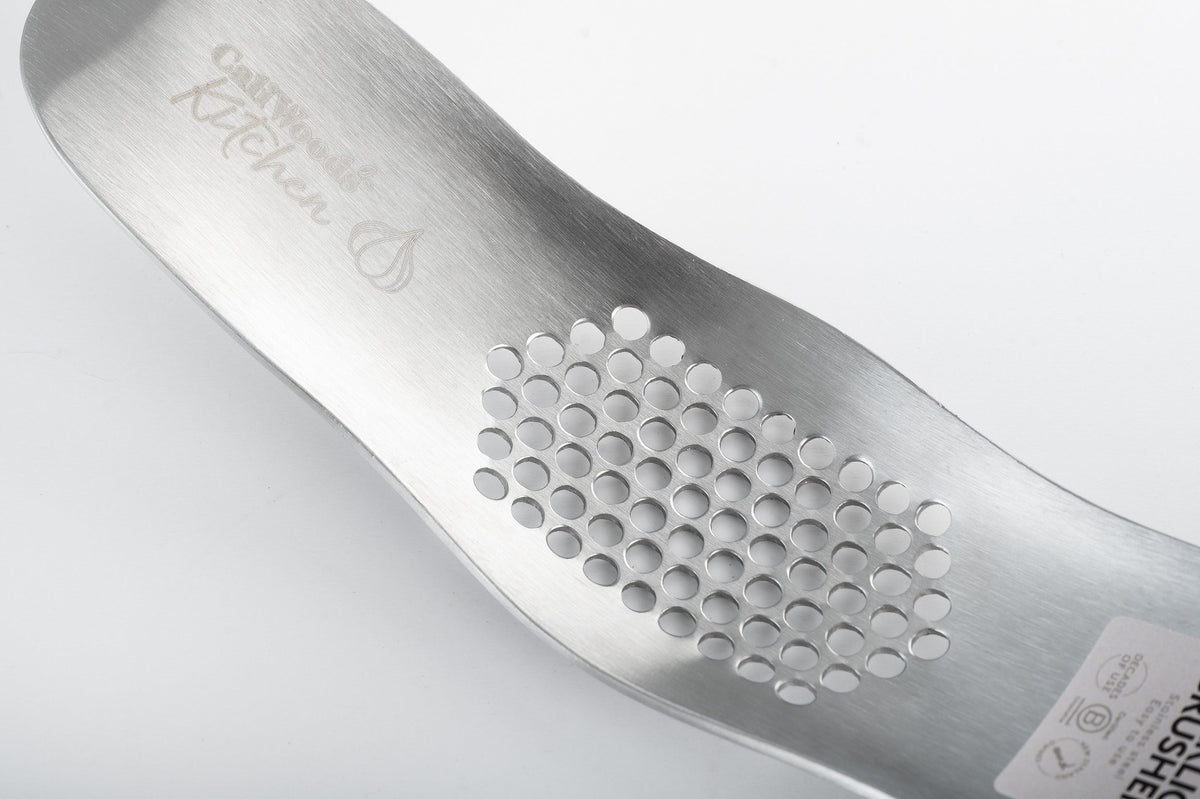 Crushing a garlic clove with the CaliWoods Garlic Crusher