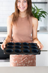 Reusable Muffin Cups on a tray with woman smiling