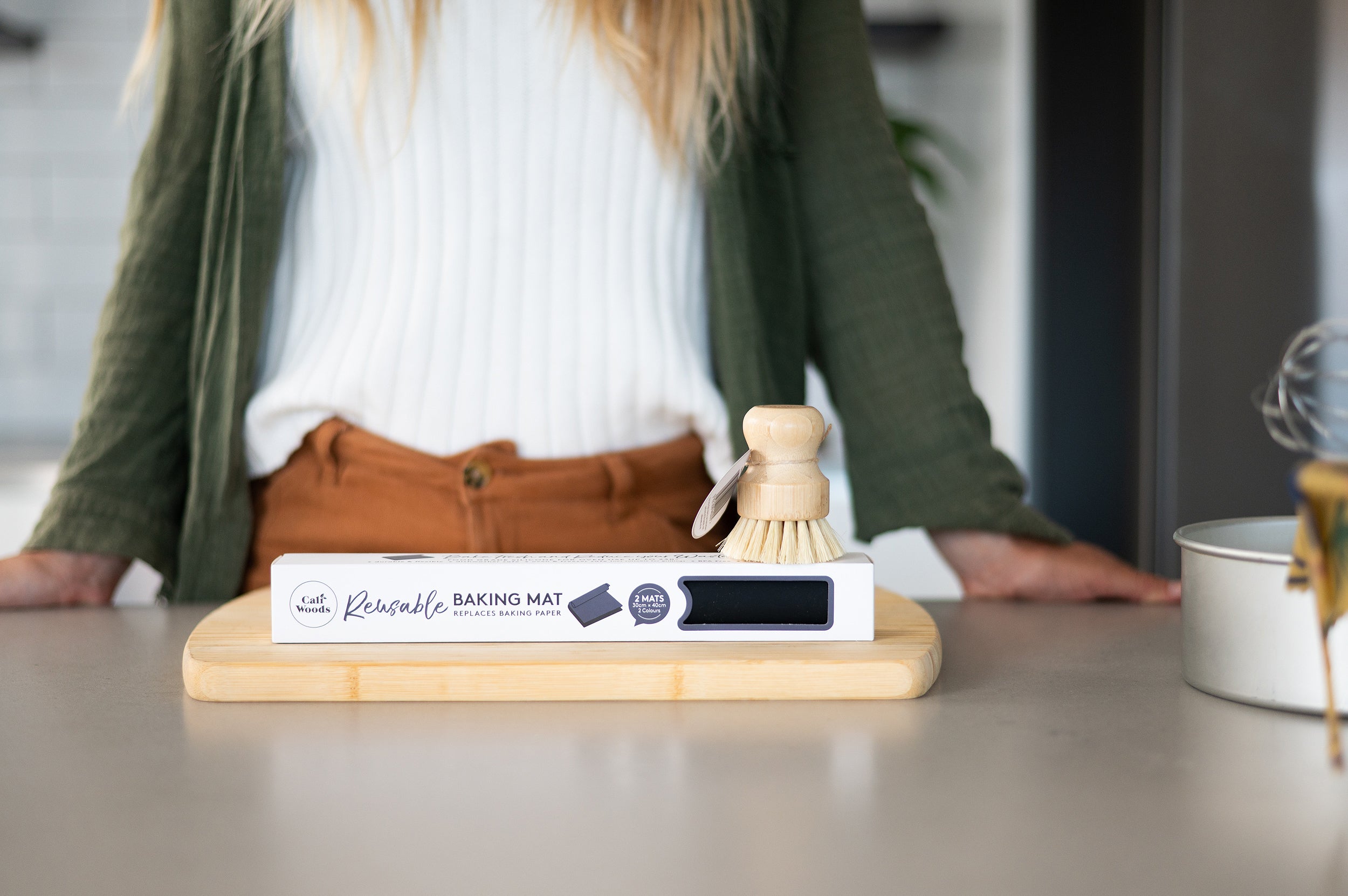 Reusable Baking Mat with woman and dishbrush in the background