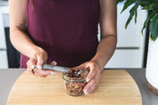 CaliWoods Stainless Steel Tea Infuser being filled with fruity loose leaf herbal tea 