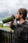 Man drinking from huge 1.9L Moss Dawny Adventure Club water bottle