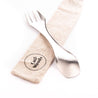 Spoon, knife, and fork in one. The CaliWoods Spork on the linen travel bag